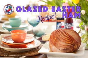 Easter set table with TPJ products blurred in the background and a spiral cut ham on a white platter