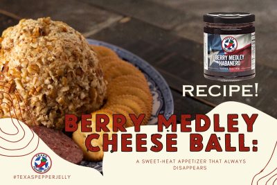 Berry Medley cheese ball with pecan coating served alongside crackers and a jar of pepper jelly